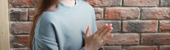 Woman sat with hands together