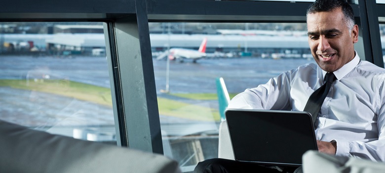 Man working his laptop at the airport