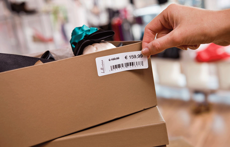 Brown shoe box being labelled with price label