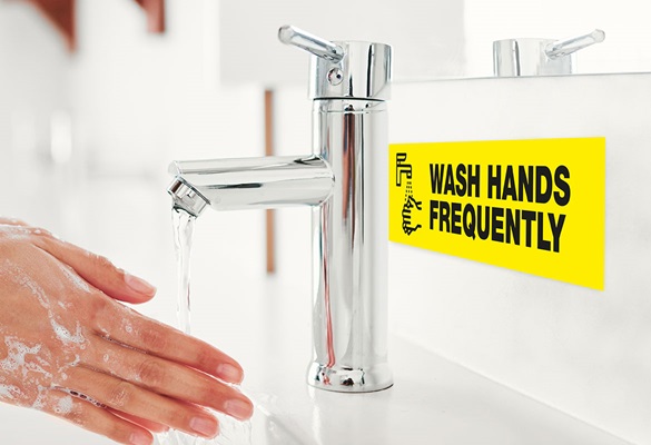 hands being washed with label visible on the splash back