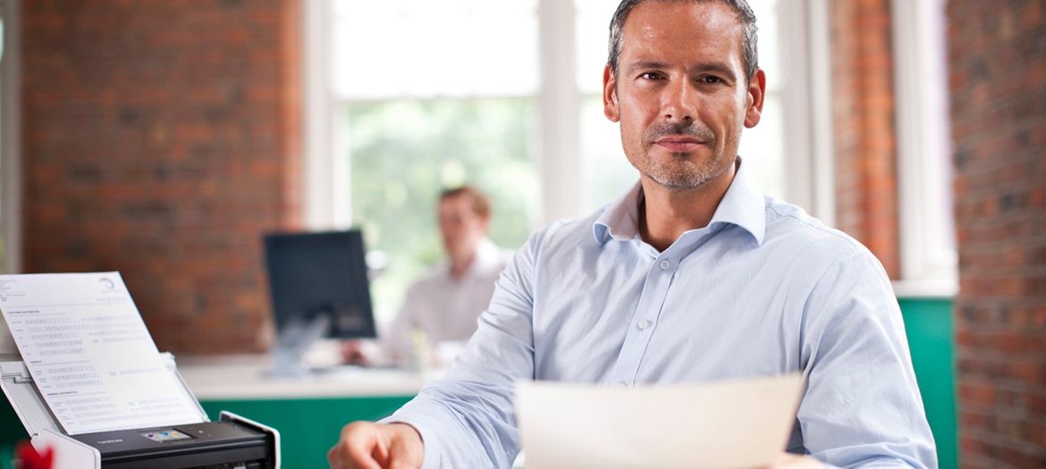 Man holding scanned document