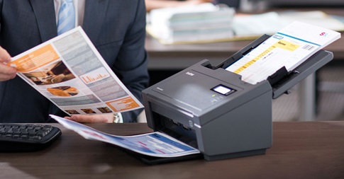 Man picking up scanned document 
